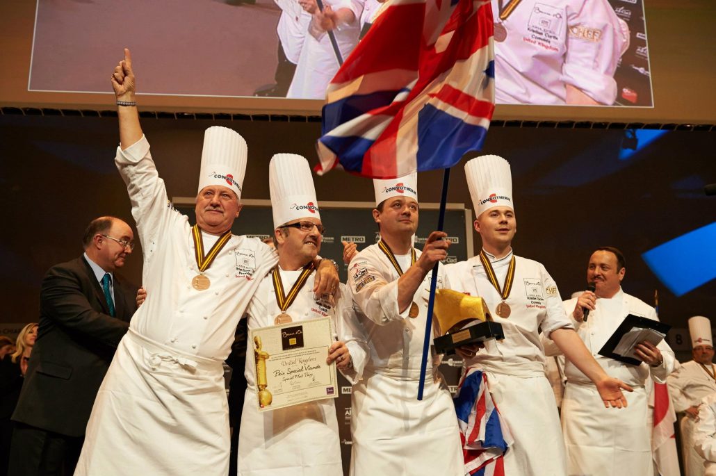 Kristian Curtis (fourth chef from the left) celebrating on stage with his teammates.