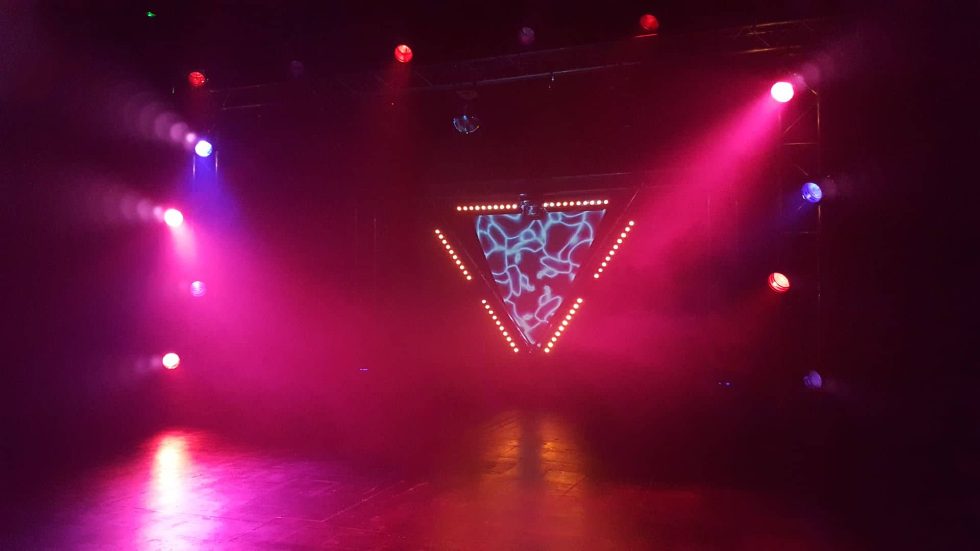 Stage lit with coloured lighting.