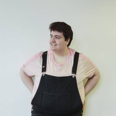 College DJ posing against a wall