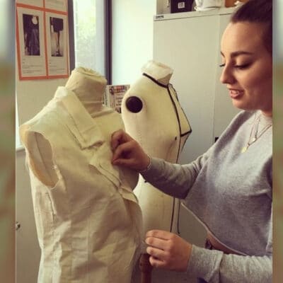Student pinning dressmakers mannequin
