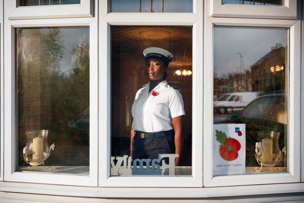 Nicole stood in her window with poppy in window