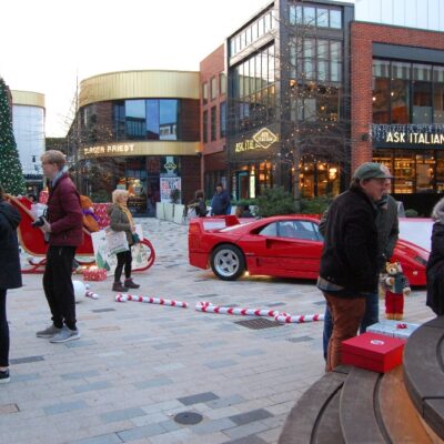 Students standing around in front of Ferrari