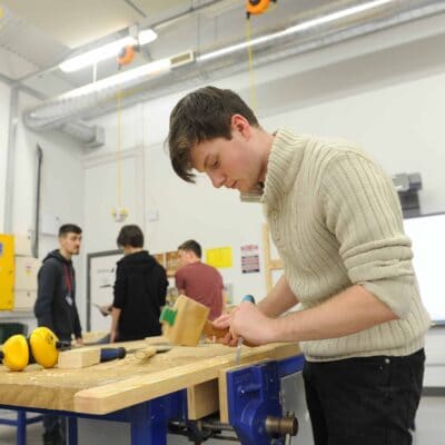 Student working on wood at Stratford-Upon-Avon College