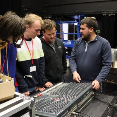 John with students at a sound desk at stratford-upon-avon college