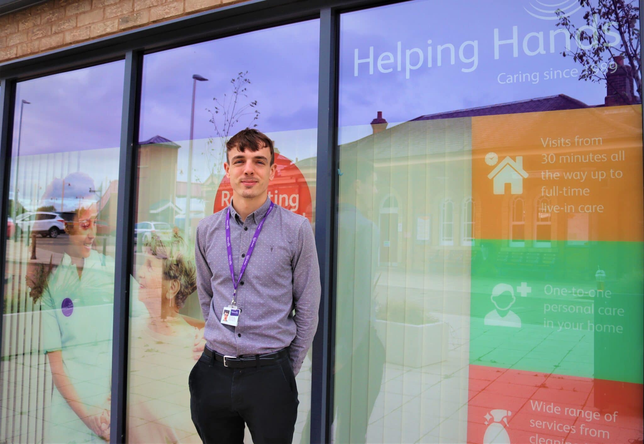 Brandon Shiels outside Helping Hands branch at stratford-upon-avon college