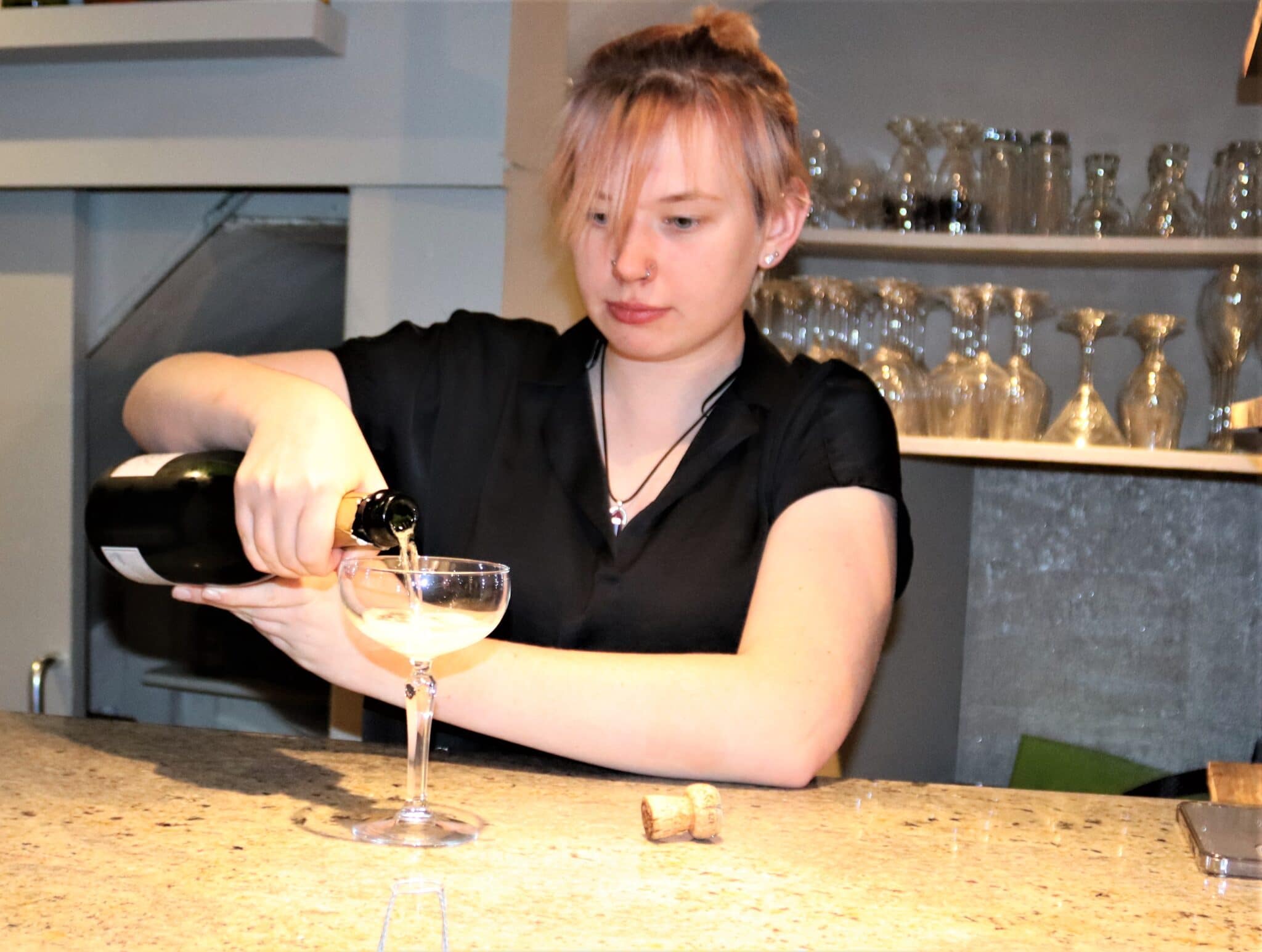 Aimie at work pouring cocktails for catering apprenticeship
