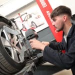 Stratford-upon-Avon College Motor Vehicle student working on car wheel.