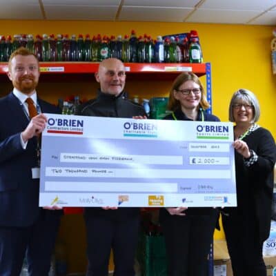 college and obriens donate to foodbank with giant cheque