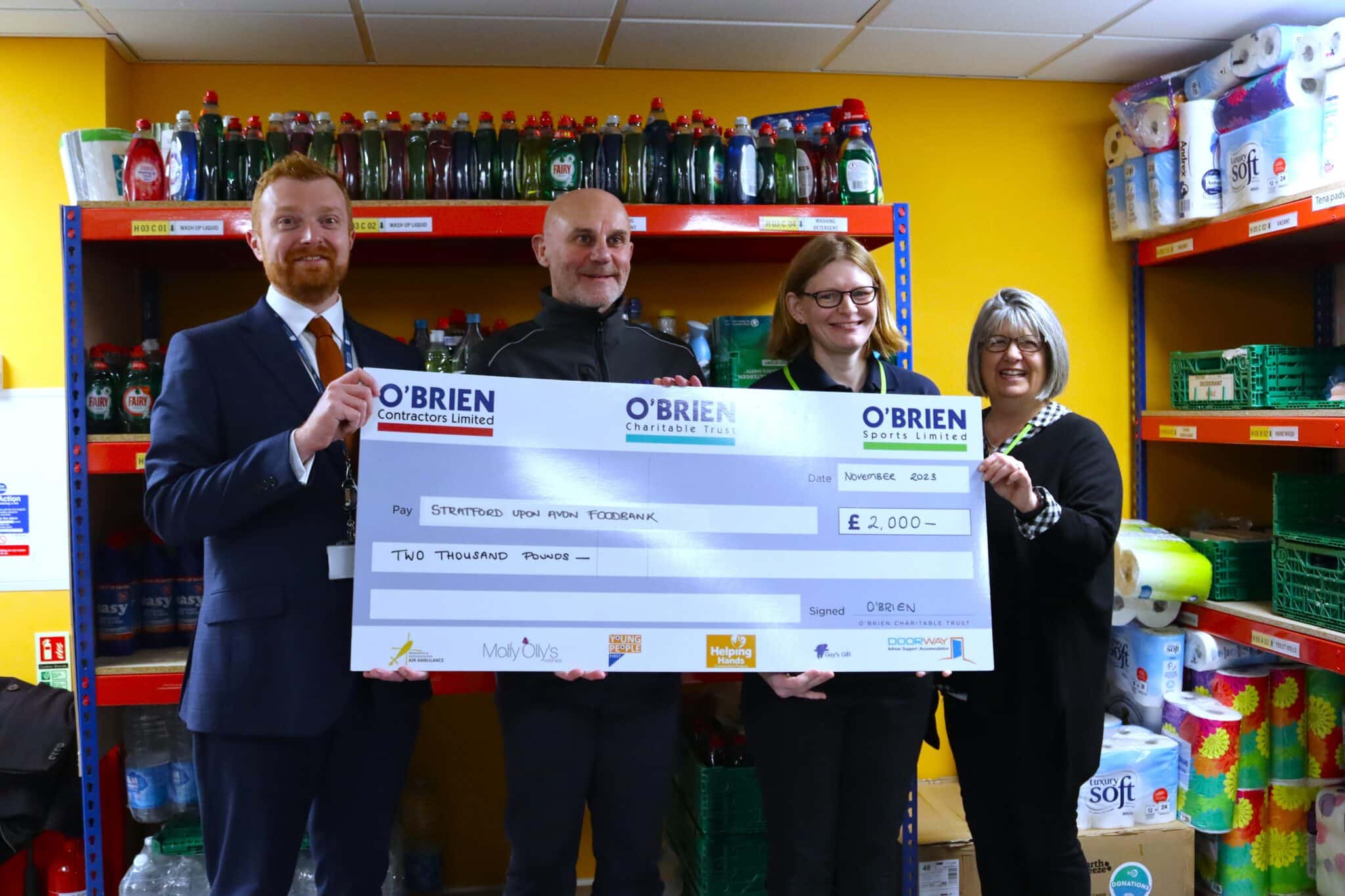 college and obriens donate to foodbank with giant cheque