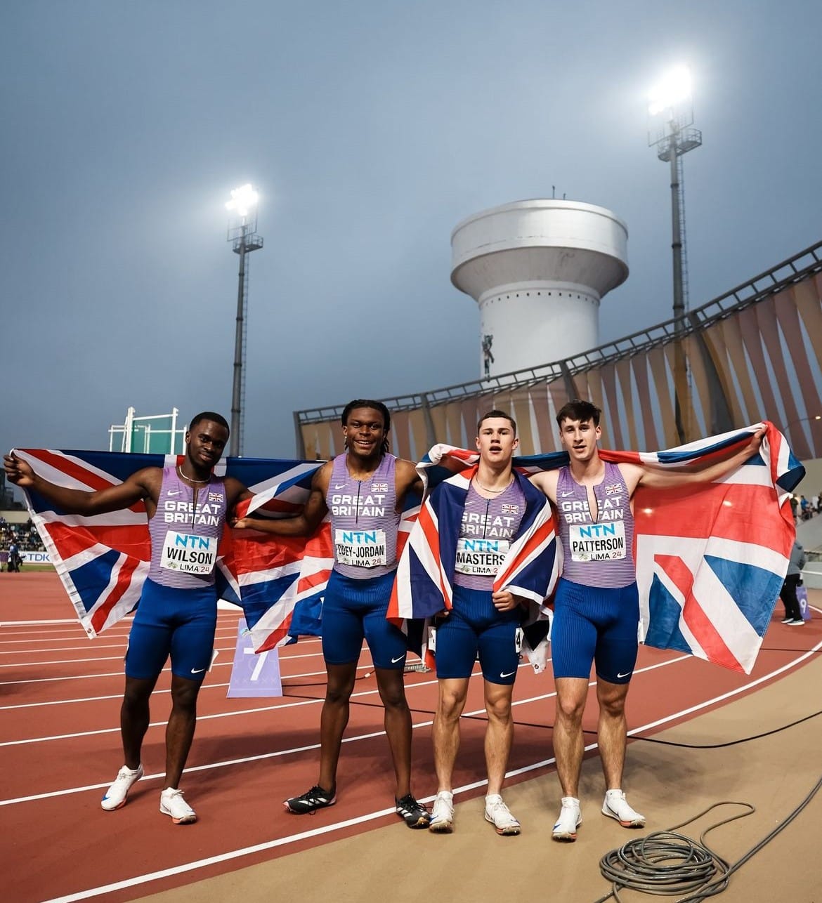 Sport student brings home World Championship medal - Four GB Athletes holding Great Britain Flag