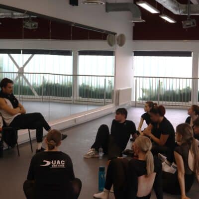 Students sat in a dance studio taking part in a Q&A