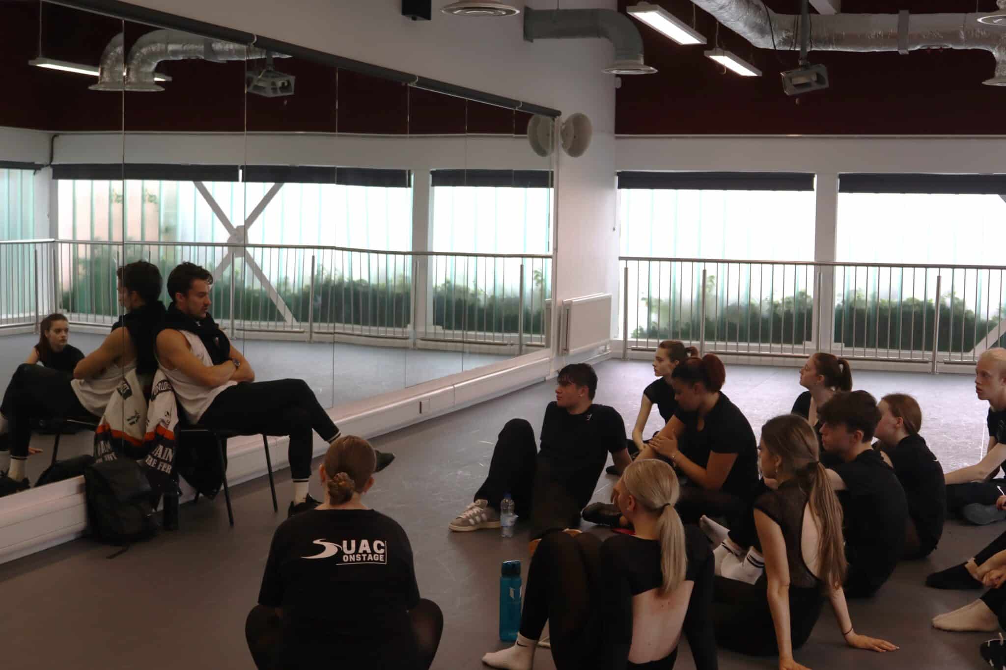 Students sat in a dance studio taking part in a Q&A