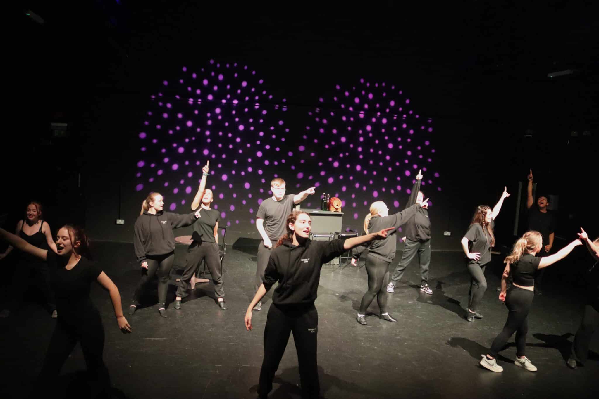 Stratford College Students performing a song on stage