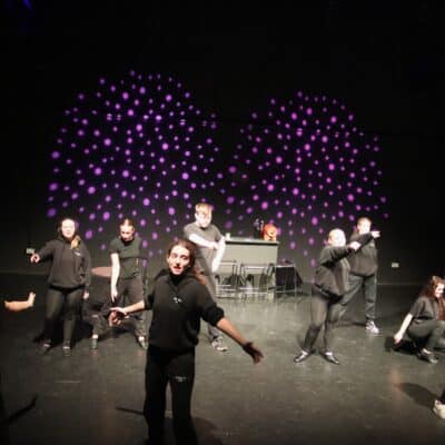 Stratford College Students performing a song on stage