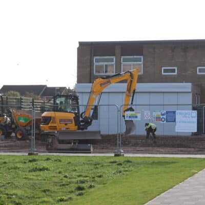 Workmen using a digger on Stratford College College campus.