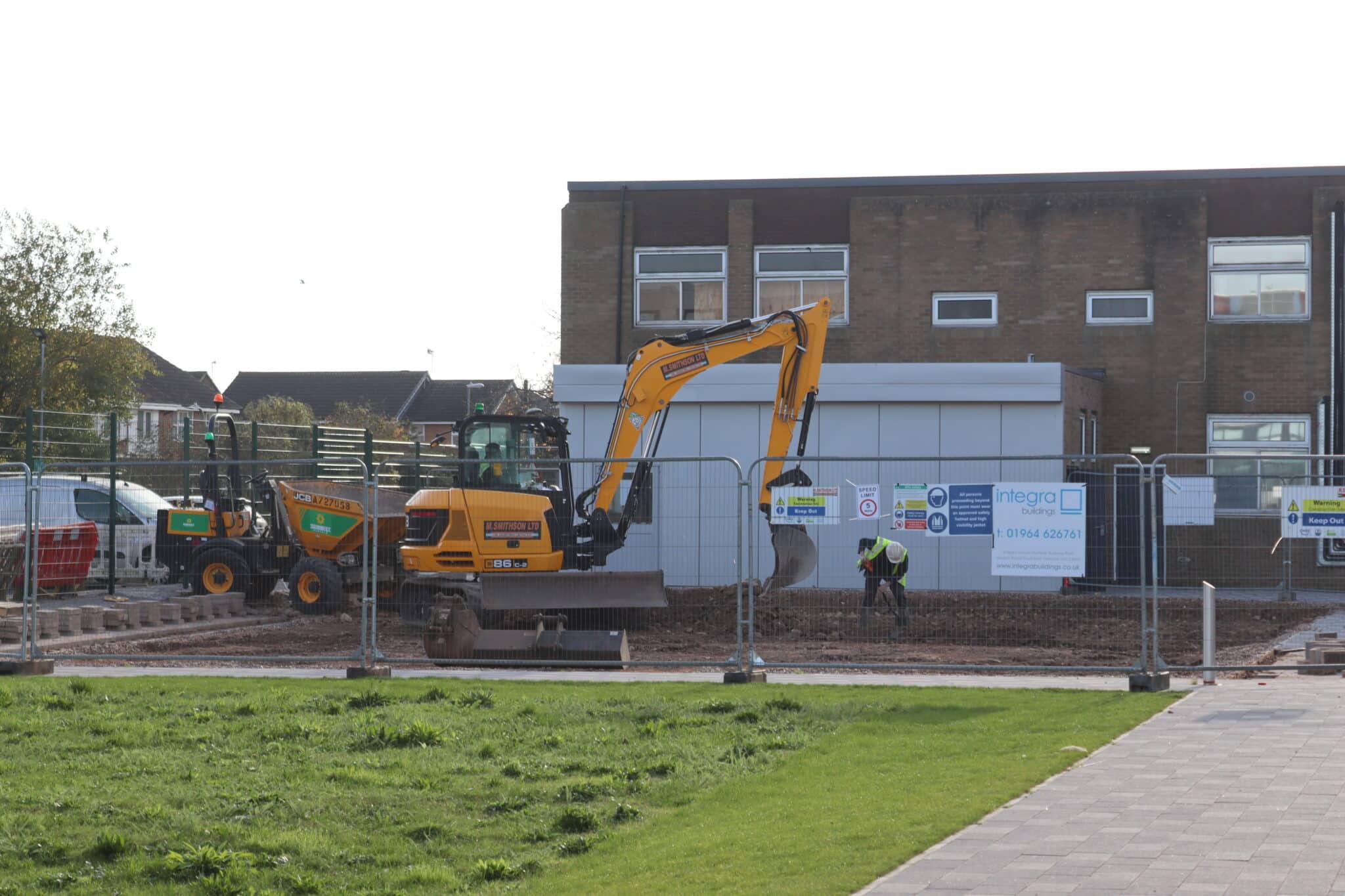 Workmen using a digger on Stratford College College campus.