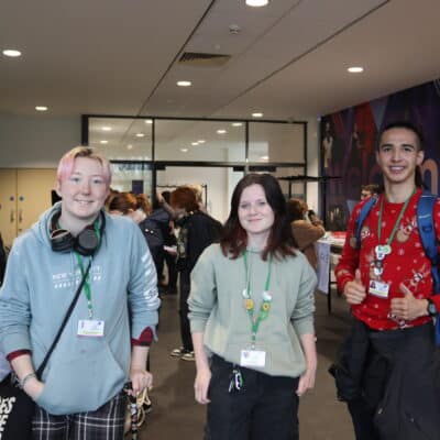 3 students smiling for a picture