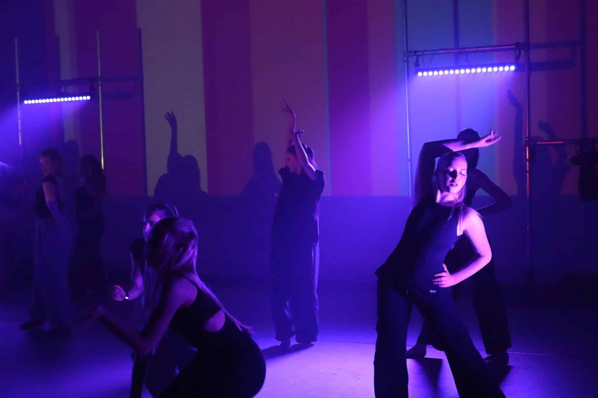 Dancer posing in purple light