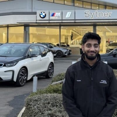 Man stood in front of BMW sign